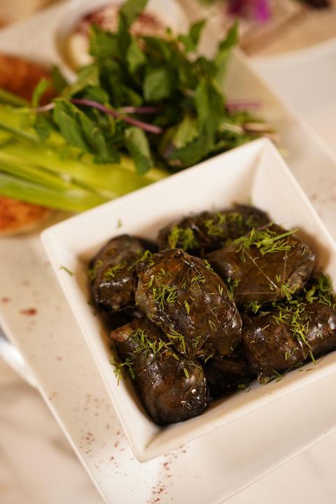 Dolma Baku: grape leaves stuffed with meat and rice, topped with dill